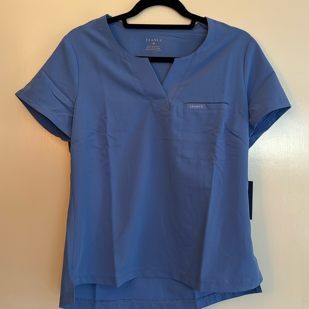 NWT Jaanuu one pocket tuck in scrub top. Ceil blue women’s size medium
